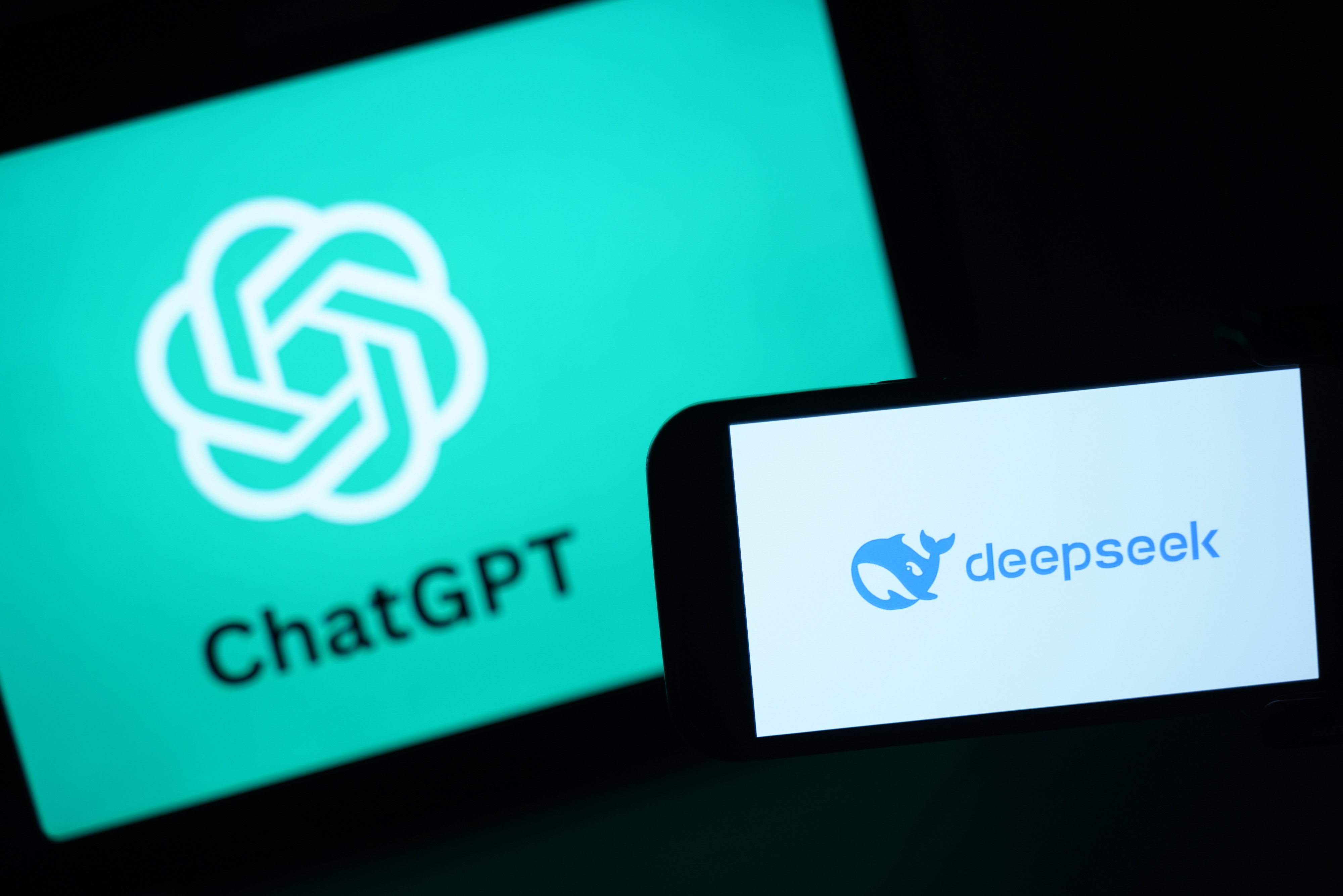 Illustration of the DeepSeek logo on a smartphone screen next to the ChatGPT logo on a larger screen.