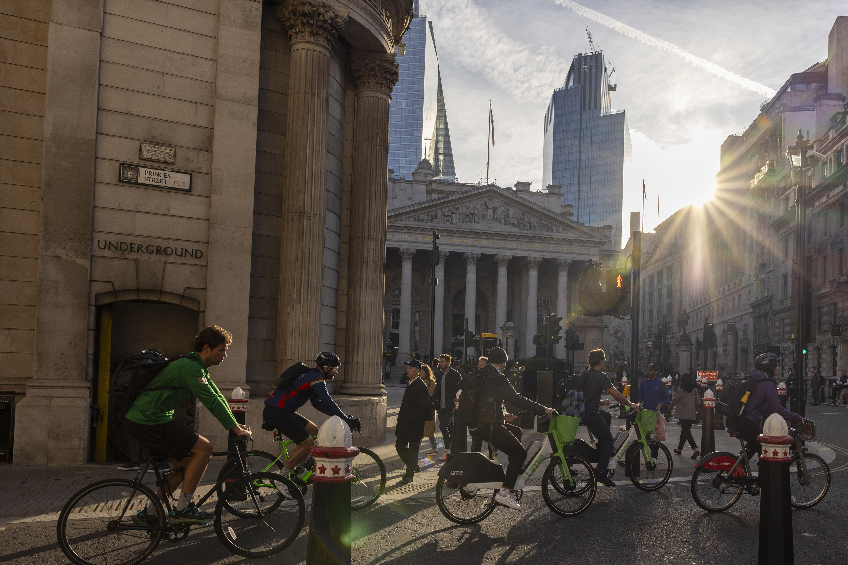 Commuters cycle past the Bank of England in the City of London.
