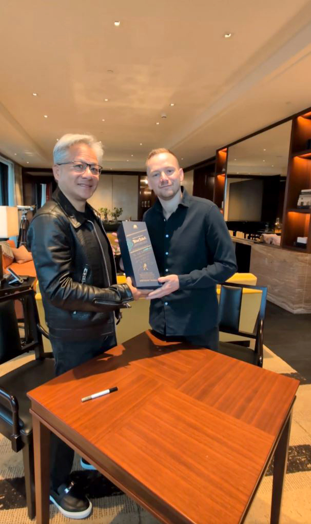 Two men exchanging a bottle of Johnnie Walker whisky.