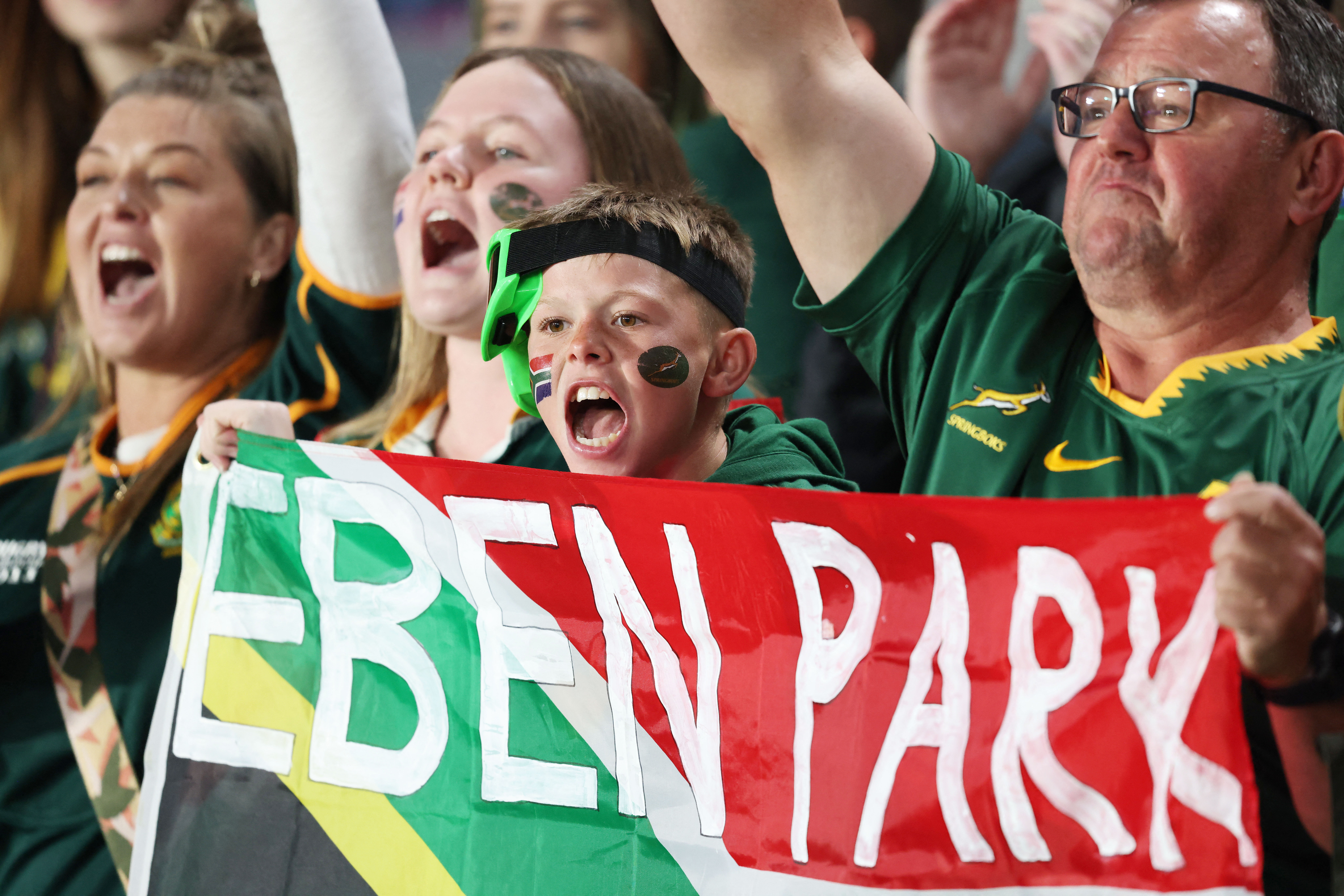 South African rugby fans at Eden Park holding a banner.
