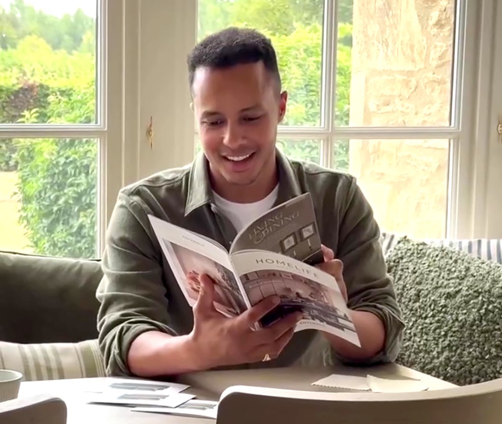 Will Kirk reviewing a Homelife Living & Dining catalog.