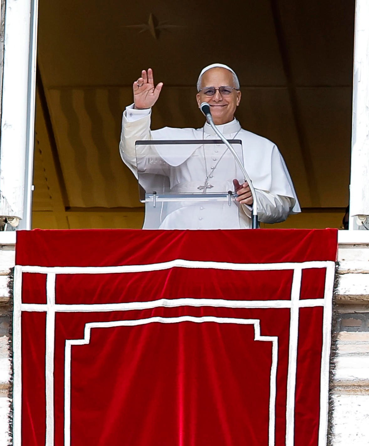 Pope Leo XIV leading the Angelus prayer from a Vatican City window.