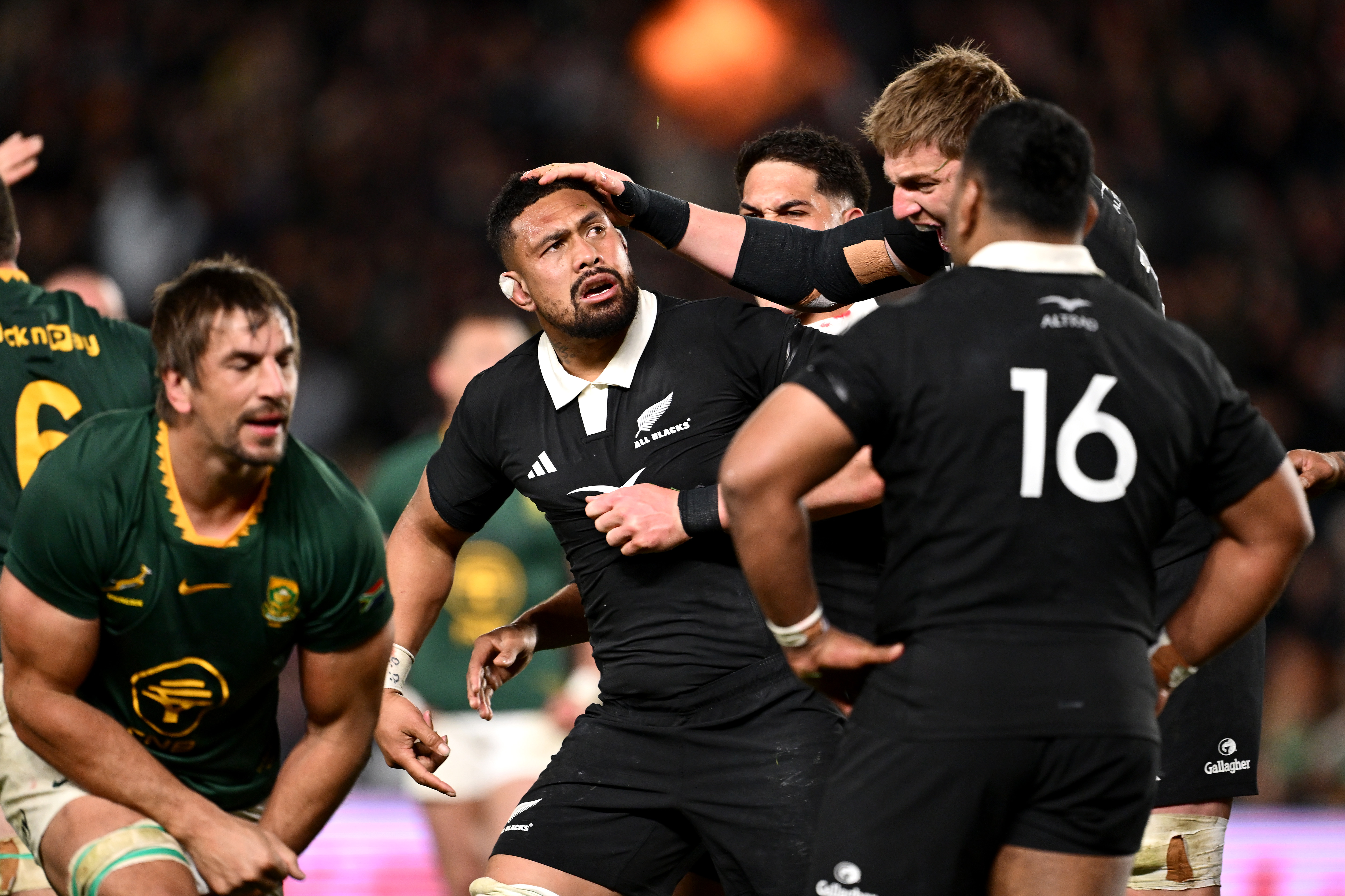 New Zealand All Blacks celebrating after a penalty during a rugby match.