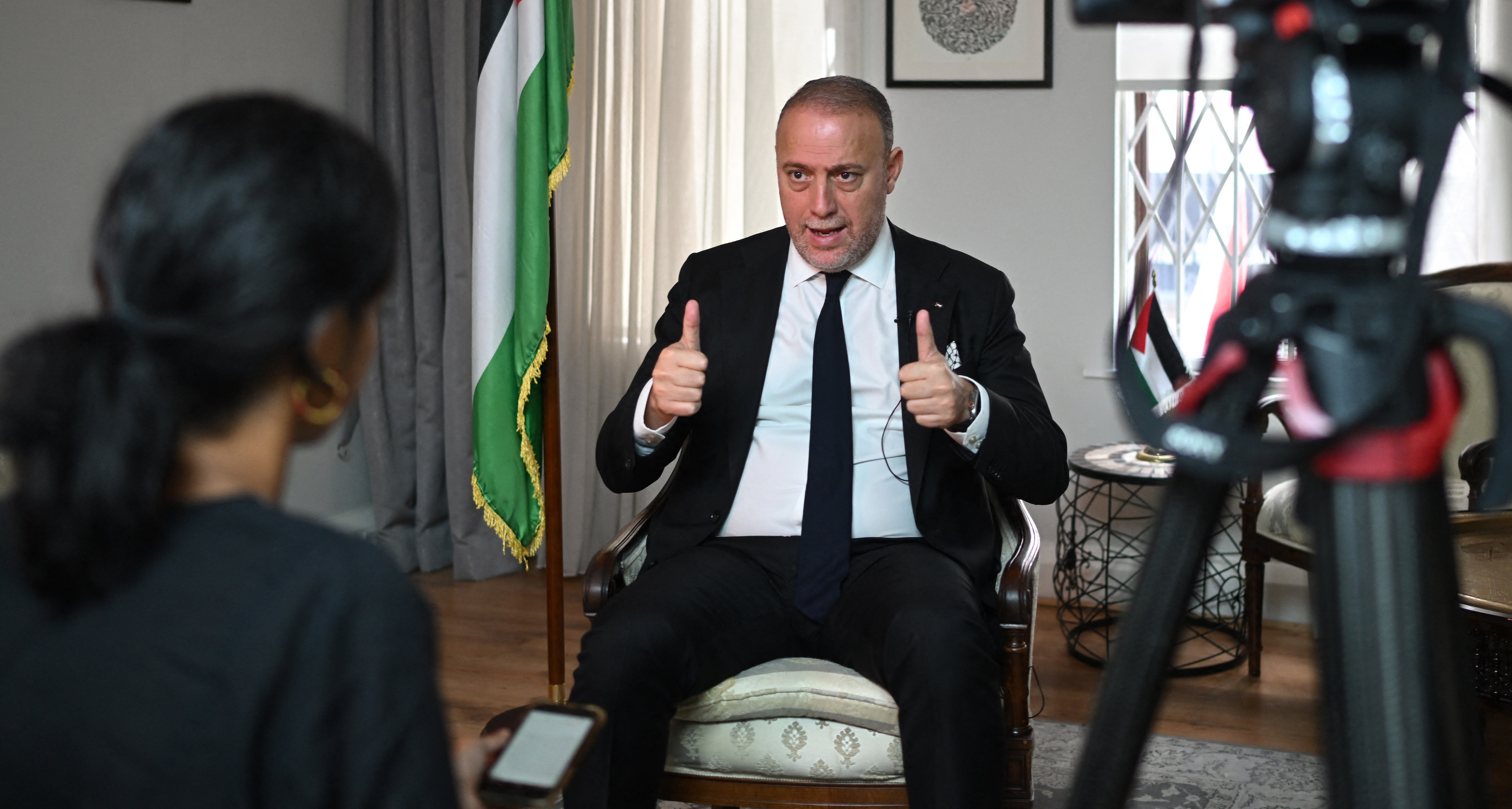 Husam Zomlot, Head of the Palestine Mission to the UK, giving a thumbs-up during an interview.