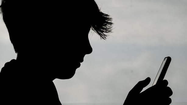 PENZANCE, UNITED KINGDOM - MAY 26: In this photo illustration, a 13-year-old boy looks at an iPhone screen on May 26, 2025 in Penzance, England. The amount of time children spend on screens each day rocketed during the Covid pandemic by more than 50 per cent, the equivalent of an extra hour and twen