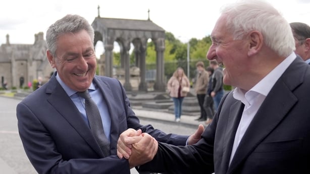 Bertie Ahern and Billy Kelleher share a laugh in Glasnevin