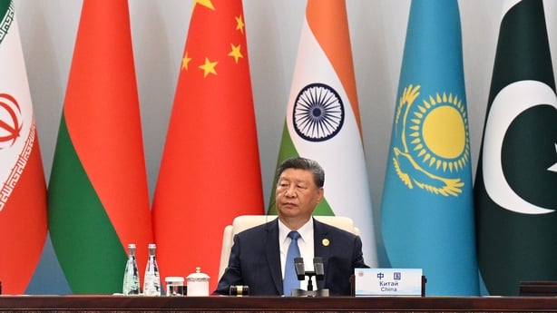 Chinese President Xi Jinping sitting at a desk at the 25th Summit of Heads of State Council Extended Session of the Shanghai Cooperation Organisation.