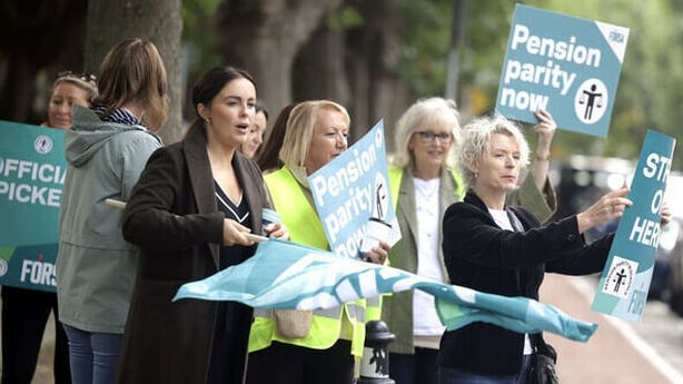 School caretakers and secretaries are pictured on the picket line outside St Vincent dePaul Infant primary school in Dublin