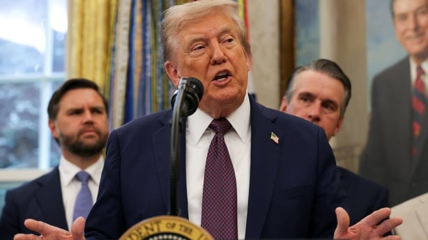 Donald Trump speaks to the media in the Oval Office at the White House