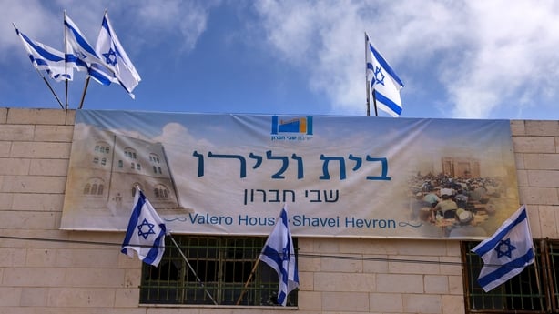Israel flags and a sign adorn a house at the entrance of the Palestinian market in the old city of Hebron