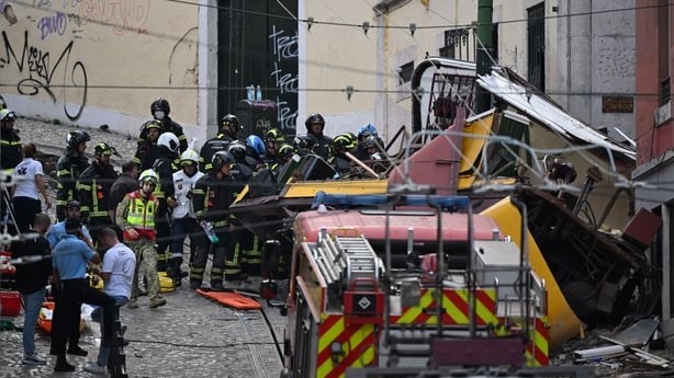 LISBON, PORTUGAL - SEPTEMBER 03: Rescuers and firefighters operate at the scene after the Gloria funicular cable railway derailed in Lisbon, Portugal, 03 September 2025. At least 15 died in the derailment, with emergency services reporting that 20 were injured and others are still trapped at the sce
