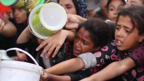 GAZA CITY, GAZA - SEPTEMBER 4: Children hold empty pots as they wait in line to receive food distributed by a charity in Nuseirat Refugee Camp amid the ongoing blockade and Israeli attacks that have left Palestinians struggling to access basic supplies in the Gaza Strip on September 4, 2025. (Photo 