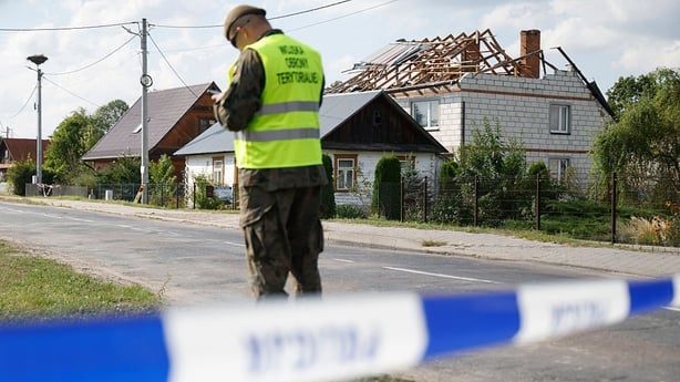 Police and army inspect damage to a house destroyed by debris from a shot down Russian drone in the village of Wyryki-Wola, eastern Poland