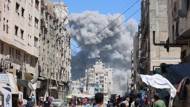 Smoke billows after an Israeli strike on Al-Nassr Street in Gaza City 