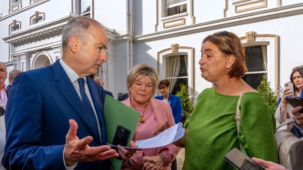 Antoinette Burke (right), mother of Katie Burke from Cobh, confronts Taoiseach Micheal Martin