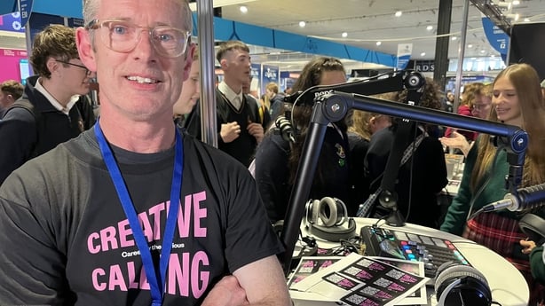 Garry McHugh with podcasting equipment and students