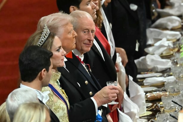 Britain's King Charles III (C) glances while standing beside US President Donald Trump at a State Banquet at Windsor Castle, in Windsor, on September 17, 2025, during the second State Visit of US President Donald Trump. US President Donald Trump arrived in Britain for an unprecedented second State V