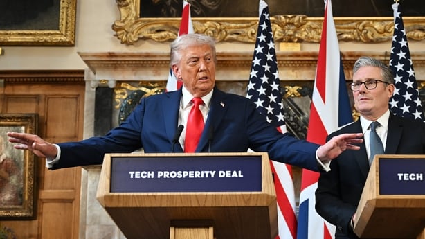 US President Donald Trump extends his arms while talking at a press conference with UK Prime Minister Keir Starmer