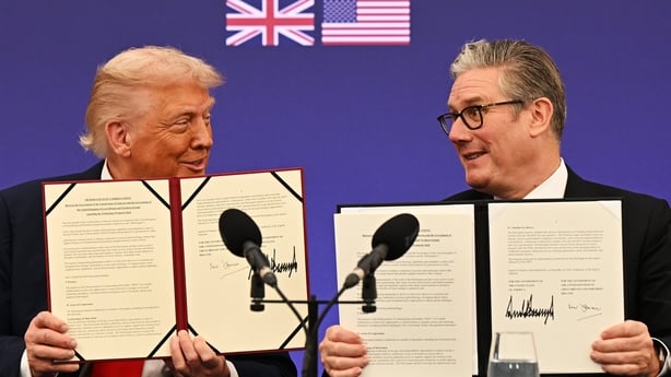 US President Donald Trump and UK Prime Minister Keir Starmer hold up signed agreements