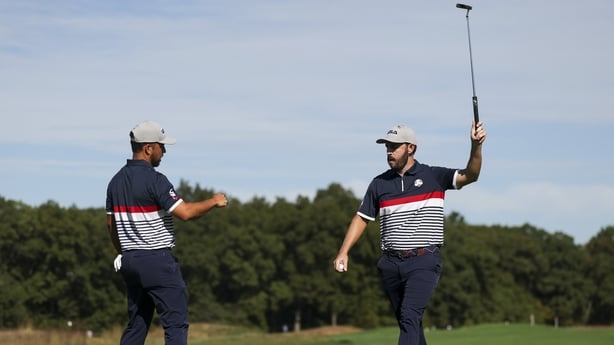 Patrick Cantlay and Xander Schauffele of Team United States react after making a putt on the 11th hole during the Friday morning foursomes matches of the 2025 Ryder Cup at Black Course at Bethpage State Park Golf Course on September 26, 2025 in Farmingdale, New York.