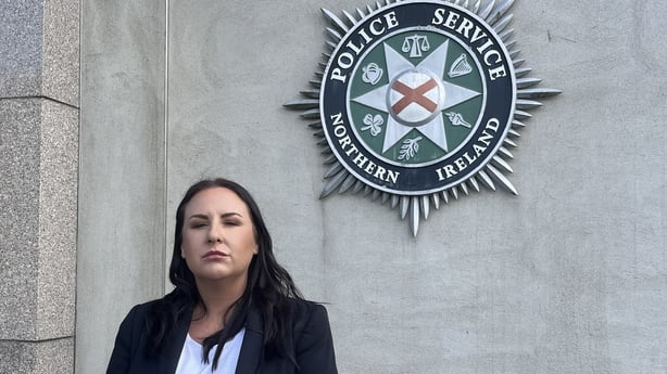 A police officer stands in front of a building