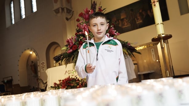 Calum Cooney holds a candle