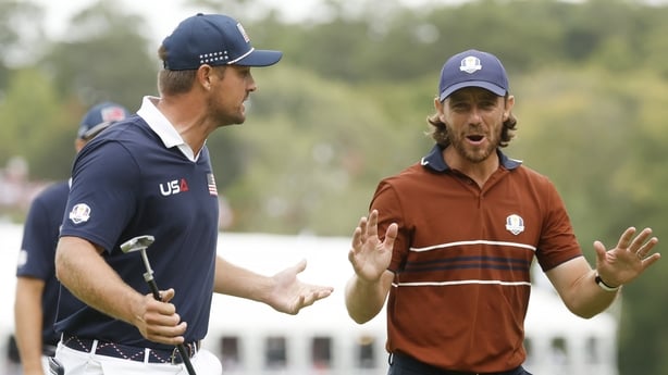 Tommy Fleetwood of Team Europe and Bryson DeChambeau of Team United States exchange words as they walk to the 16th hole during the Saturday afternoon four-balls matches of the 2025 Ryder Cup at Black Course at Bethpage State Park Golf Course on September 27, 2025 in Farmingdale, New York.