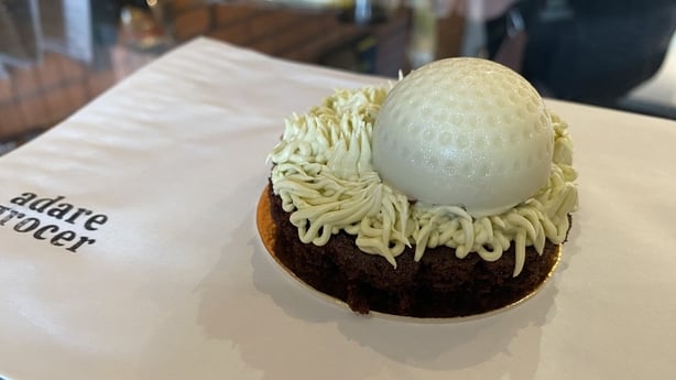 A cake with a white golf ball on top