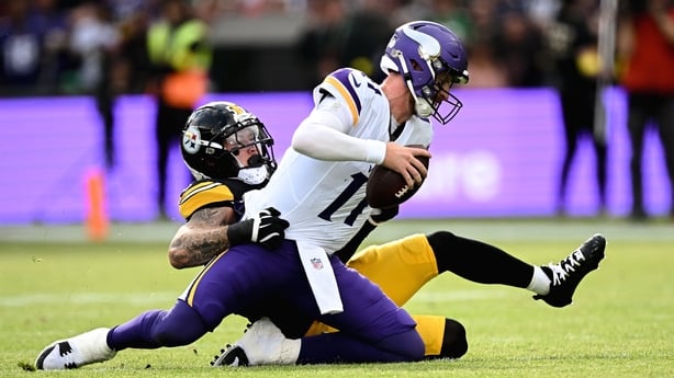 28 September 2025; Quarterback Carson Wentz #11 of Minnesota Vikings is tackled by Linebacker Nick Herbig #51 of Pittsburgh Steelers during the 2025 NFL International Game between the Pittsburgh Steelers and the Minnesota Vikings at Croke Park in Dublin. Photo by Seb Daly/Sportsfile