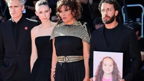 Getty Images Joaquin Phoenix, Rooney Mara, Kaouther Ben Hania and Motaz Malhees attend the The Voice Of Hind Rajab red carpet during the 82nd Venice International Film Festival