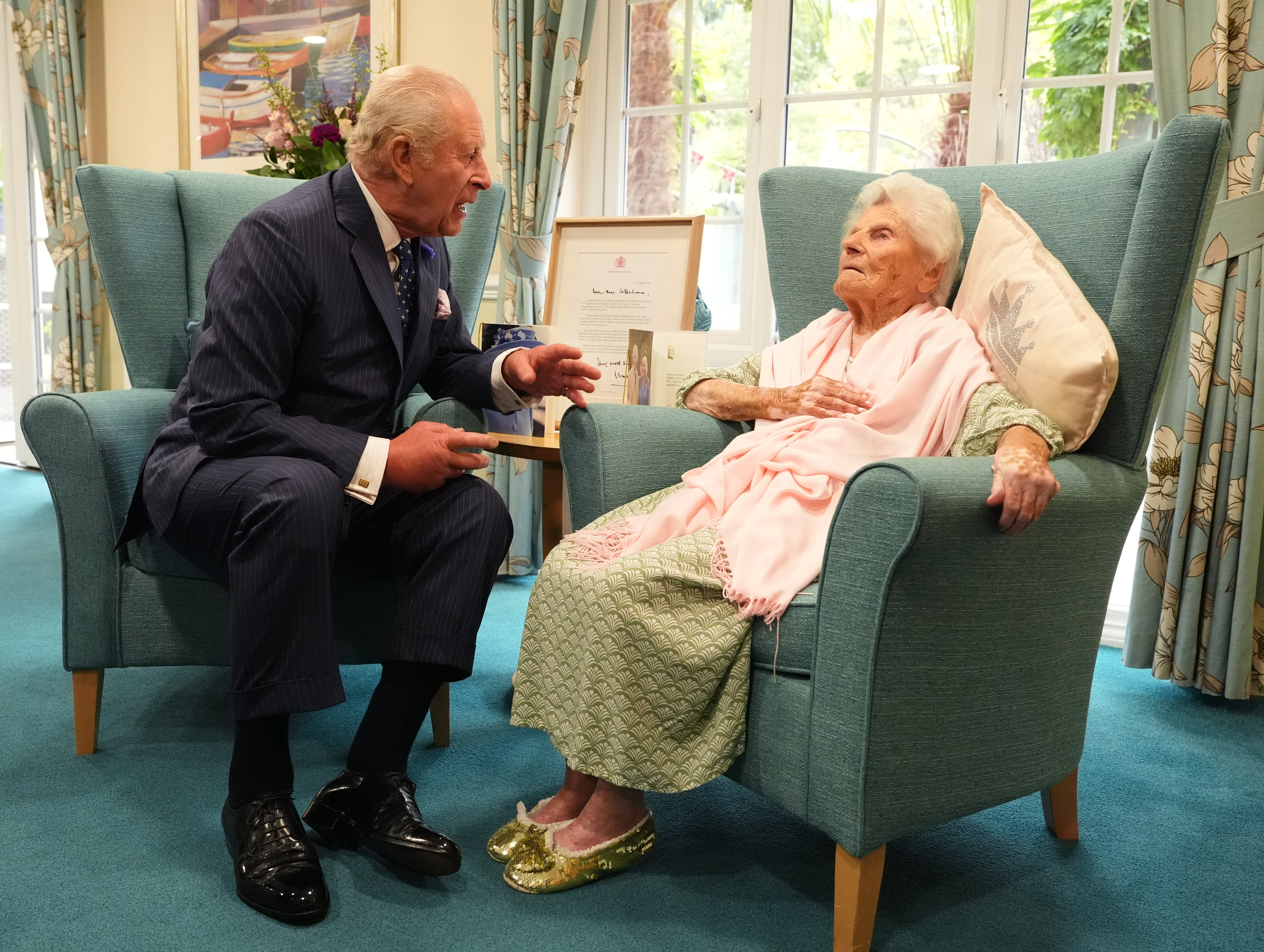 King Charles III meets the world's oldest person, 116-year-old Ethel Caterham, at Hallmark Lakeview Care Home in Lightwater, Surrey