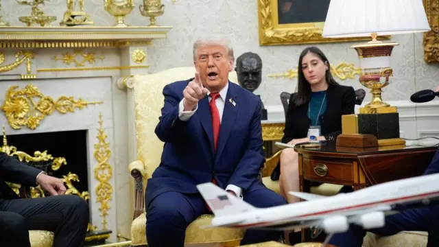 Trump speaking while pointing his finger toward the camera in the Oval Office