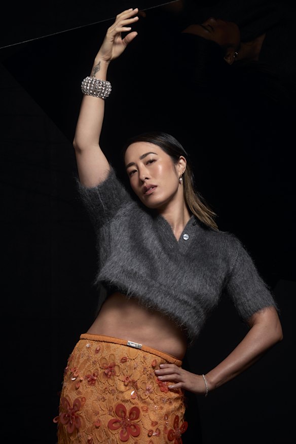 Gucci sweater and skirt, Ryan Storer bracelet.