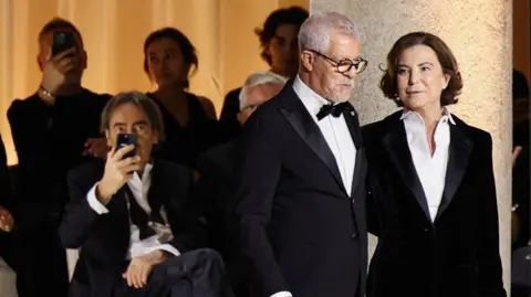 Reuters Leo Dell'Orco, head of Men's Style at Armani Group, and Silvana Armani, niece of late fashion designer Giorgio Armani, appear at the end of the Giorgio Armani Spring/Summer 2026 collection show during Fashion Week in Milan, Italy, September 28, 2025.