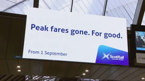 A digital billboard at Queen Street Station in Glasgow  says "Peak fares. Gone for good."
