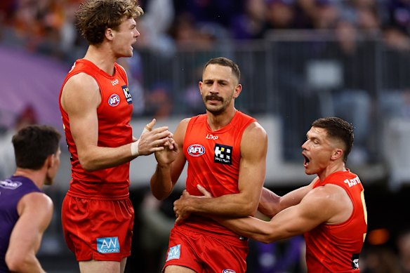 (L-R) Ethan Read, Ben Long and Ben Ainsworth of the Suns celebrate a goal.