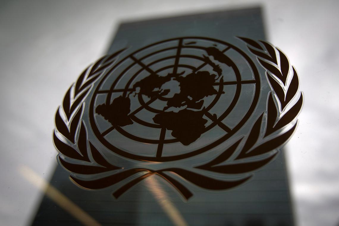 FILE PHOTO: The United Nations headquarters building is pictured though a window with the UN logo in the foreground in the Manhattan borough of New York August 15, 2014. REUTERS/Carlo Allegri/ File Photo