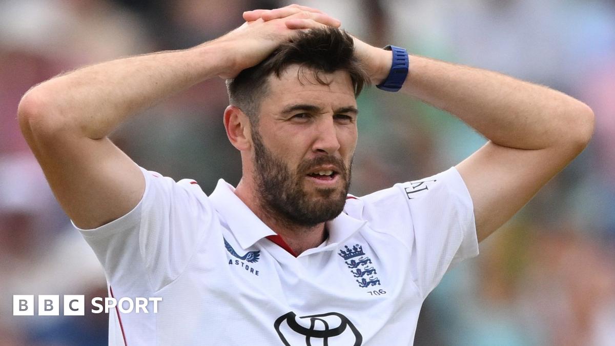 Jamie Overton, in Test whites, puts his hands on his head