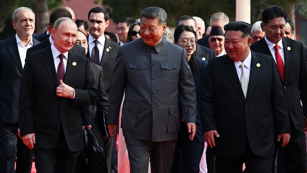 Xi Jinping — flanked by Putin and Kim — speaks of choice between war and peace at huge parade