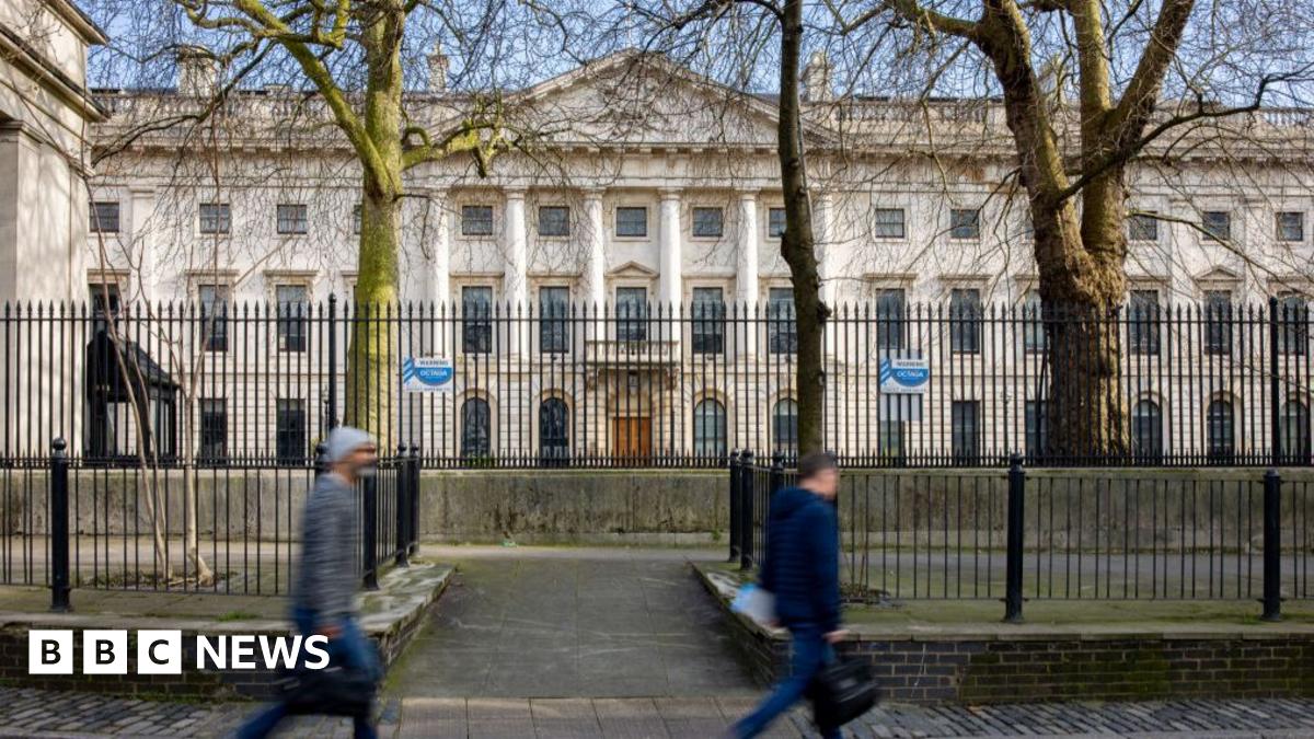 Passers-by walk past the the Royal Mint Court office complex in the City of London the possible future site of a new Chinese Embassy