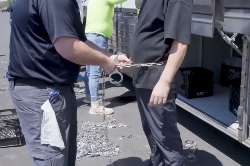 A person is chained and handcuffed at the Hyundai Motor Group’s electric vehicle plant in Ellabell, Georgia, on September 4, 2025.