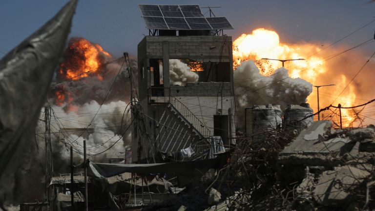 Smoke and flames rising after Israel's strike on a building in Gaza City on Saturday. Pic: AP