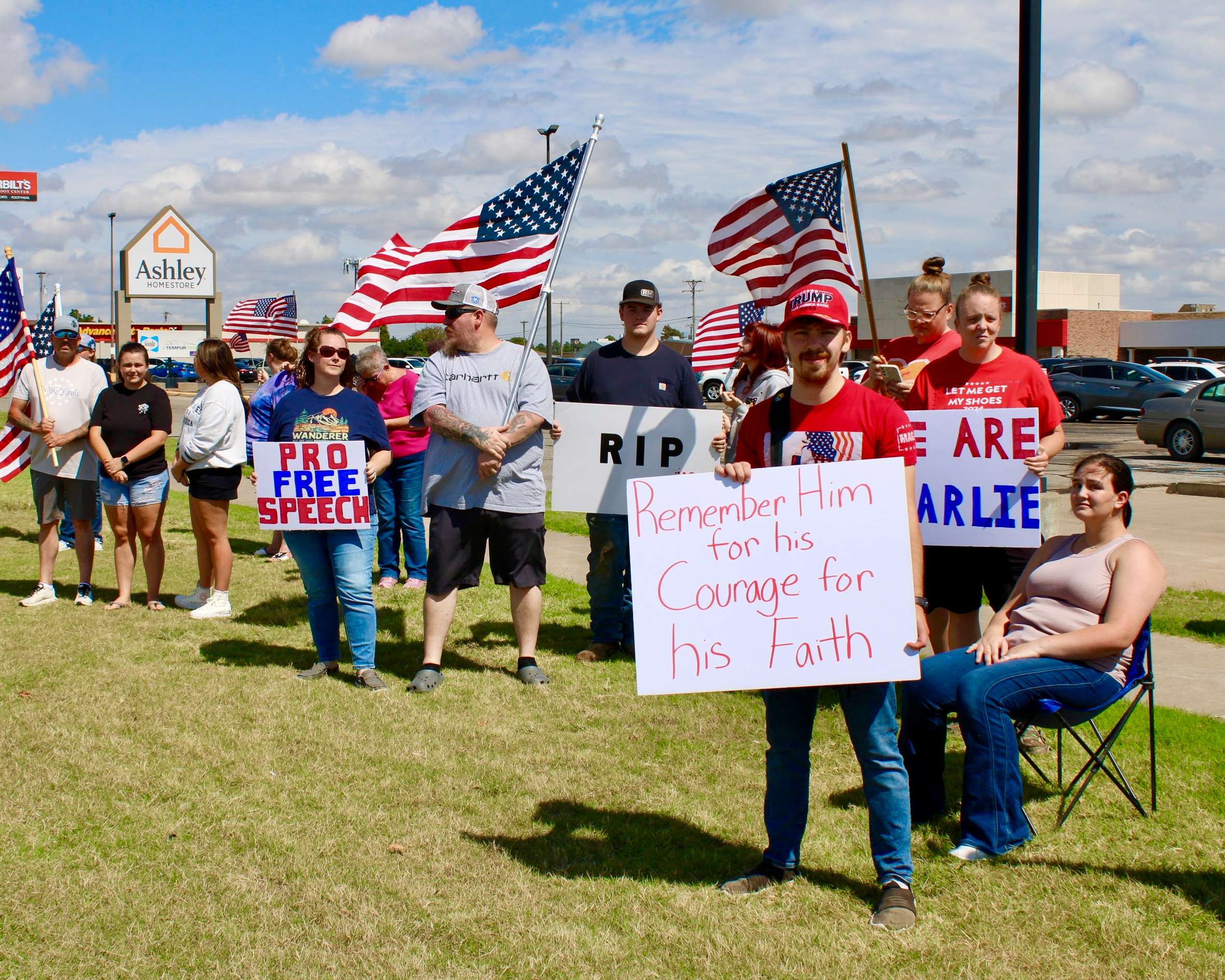 Kayson Unsworth with a sign (right) on the corner of 27th and Vine in Hays. Photo by Tony Guerrero/Hays Post