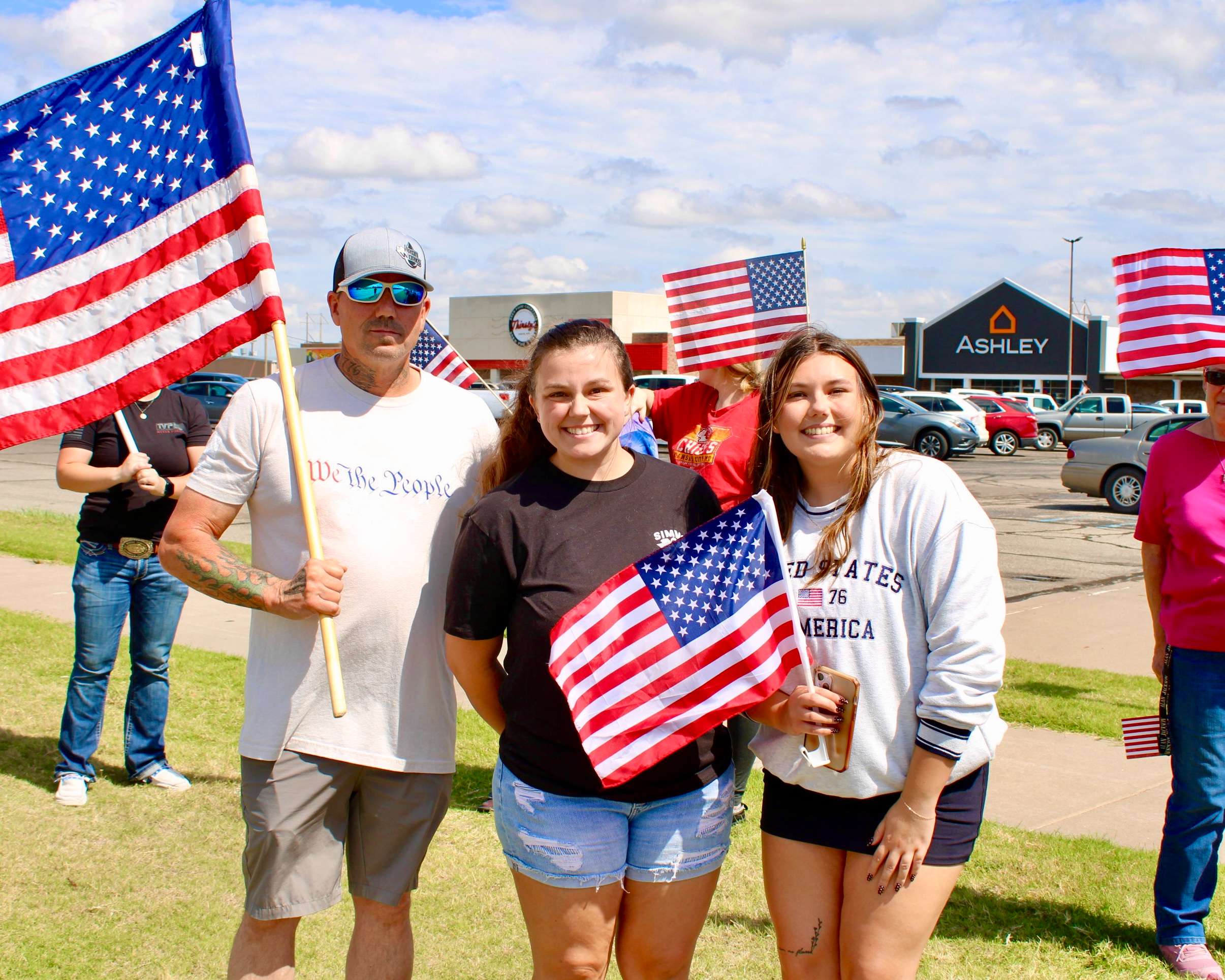 Taylor Wright (center) on the corner of 27th and Vine St. in Hays. Photo by Tony Guerrero/Hays Post