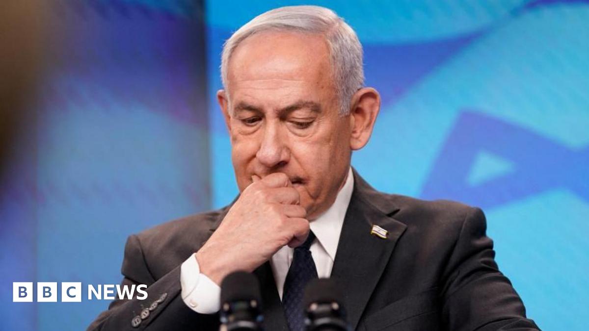 Benjamin Netanyahu looking down as he speaks on stage