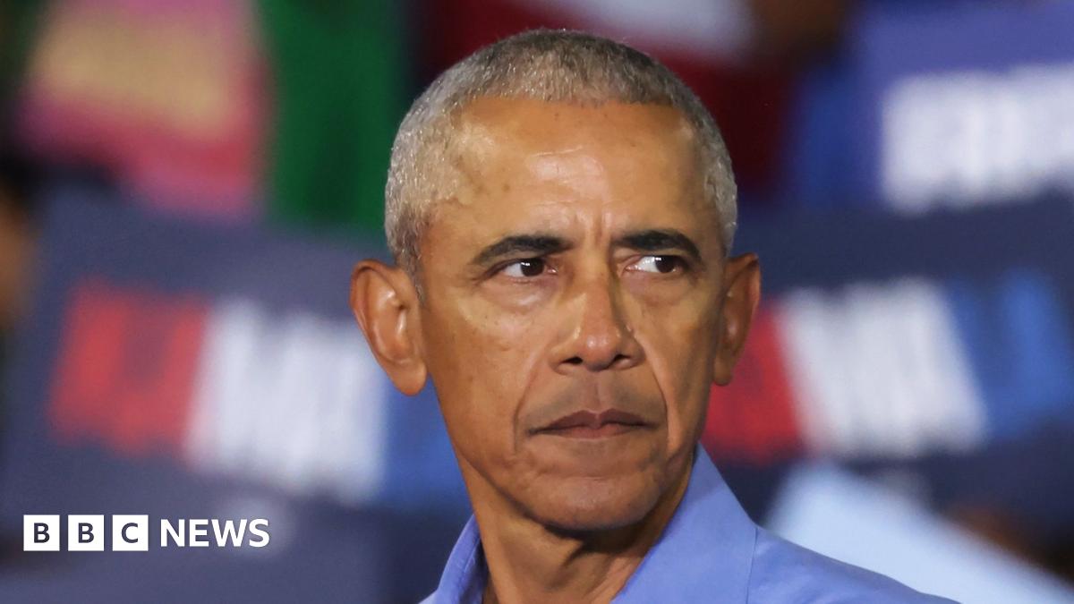 President Obama looks off camera, wearing a blue shirt