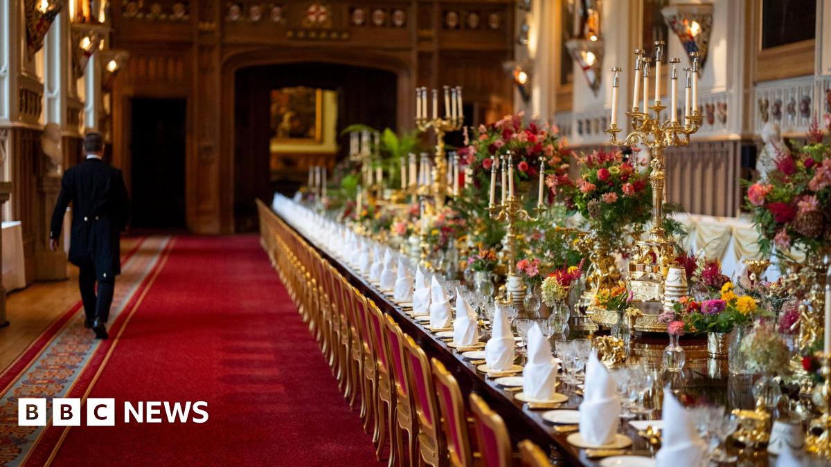 A view of the banquet table, with gold candlesticks and lots of pink and red flowers
