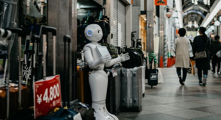 A robot which could carry out tasks assigned to humans stands in a shopping mall in Kyoto, Japan.
