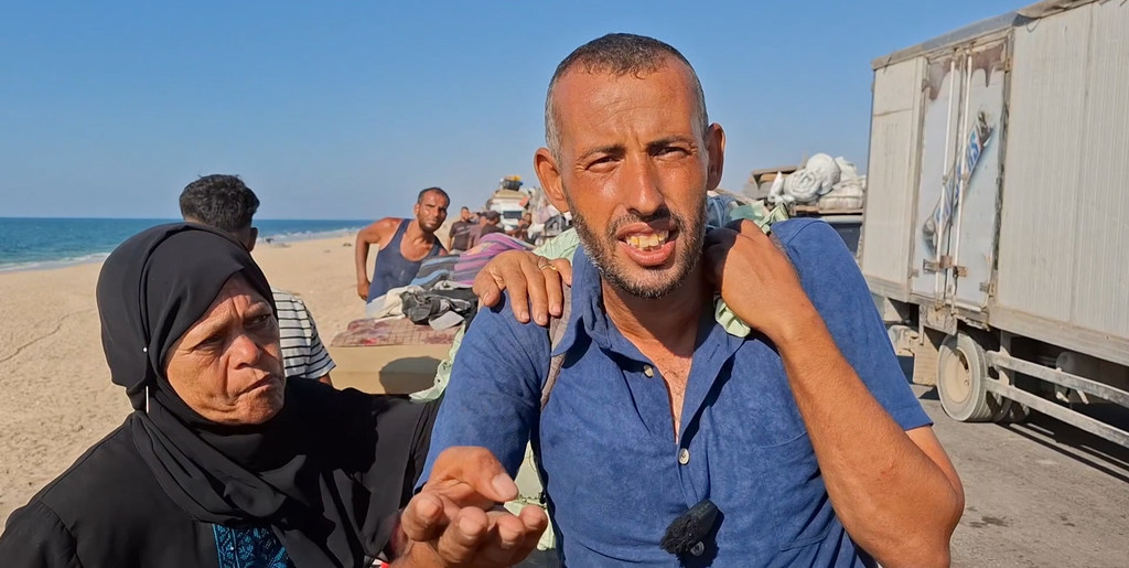 From Gaza, Ayman al-Khatib during his displacement journey on foot with his aunt.