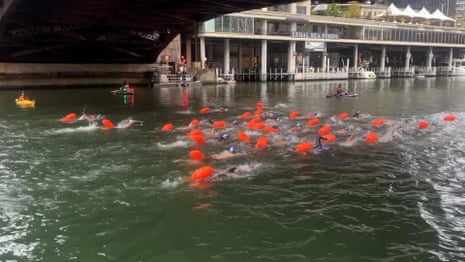 Moment hundreds of people plunge in Chicago River for first official swim in 100 years – video 